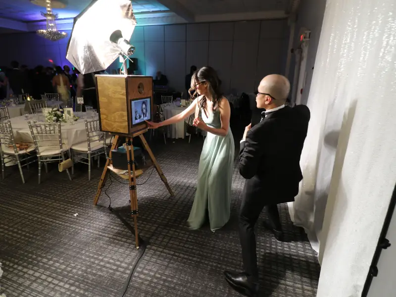 Wedding guests gathering together at the photo booth