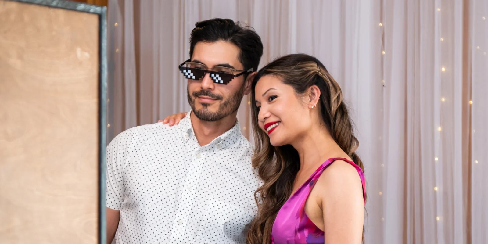 Couple enjoying a vintage wedding photobooth