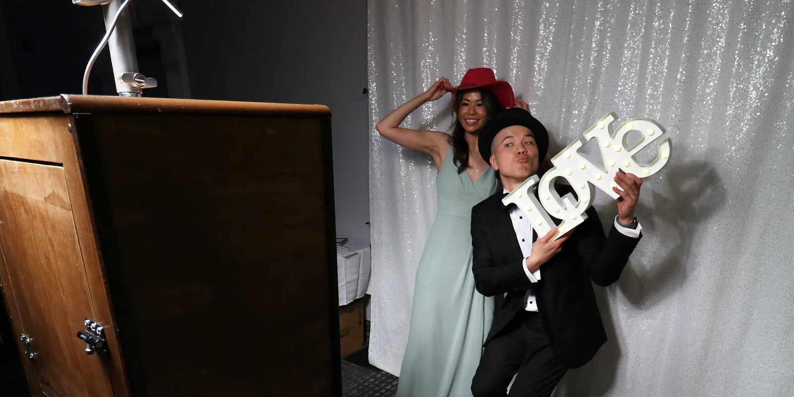 Guests having fun with wedding photobooth props